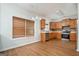 Bright eat-in kitchen with stainless steel appliances, wood cabinets, and wood-look flooring at 1870 Wildcat Trace Cir, Lawrenceville, GA 30043