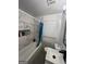 Bathroom featuring marble-style wall tiles, tiled shower niche, and modern fixtures at 4111 Scott Dr, Forest Park, GA 30297