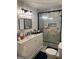 Bathroom featuring marble-style wall tiles, vanity with storage, and glass shower enclosure at 4111 Scott Dr, Forest Park, GA 30297