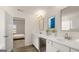 Bright bathroom featuring double sinks, white cabinets, granite counters, and tile flooring at 1809 Quaker, Hampton, GA 30228