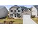 Charming two-story home featuring a brick facade, black shutters, and a well-manicured front lawn at 1809 Quaker, Hampton, GA 30228