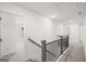 Upstairs hallway with wood and wrought iron railing overlooking the staircase and open doorways at 1809 Quaker, Hampton, GA 30228