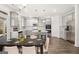 Eat-in kitchen features stainless appliances, gray cabinets, island with breakfast bar, and hardwood floors at 1809 Quaker, Hampton, GA 30228