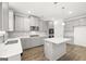 Modern kitchen with stainless steel appliances, gray cabinets, and an island with white countertop at 1809 Quaker, Hampton, GA 30228
