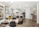 Modern kitchen with gray cabinets, stainless steel appliances, a center island, and an adjacent dining table at 1809 Quaker, Hampton, GA 30228