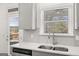 Kitchen featuring a stainless steel sink, modern faucet, and scenic outdoor view at 1809 Quaker, Hampton, GA 30228