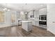 Open kitchen with hardwood floors, gray cabinets, stainless steel appliances, and island at 1809 Quaker, Hampton, GA 30228