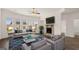 Well-lit living room with fireplace, ceiling fan, multiple windows, and modern furniture at 1809 Quaker, Hampton, GA 30228