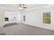 An airy main bedroom featuring multiple windows and a carpeted floor at 1809 Quaker, Hampton, GA 30228