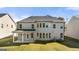 The rear exterior features a covered patio, multiple windows, and a well-maintained lawn at 1809 Quaker, Hampton, GA 30228