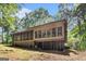 View of backyard and house featuring a screened porch and ample windows at 275 Brandon Mill Cir, Fayetteville, GA 30214