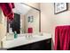 Bathroom features a white countertop vanity with dark cabinets and red towels at 275 Brandon Mill Cir, Fayetteville, GA 30214
