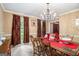 Dining room featuring large windows, chandelier, and elegant table setting at 275 Brandon Mill Cir, Fayetteville, GA 30214
