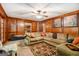 Living room featuring wood paneling and a comfortable sectional sofa at 275 Brandon Mill Cir, Fayetteville, GA 30214