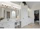 Bright bathroom has a vanity table, cabinet storage, and large decorative mirror at 240 Longmead Dr, Fayetteville, GA 30215