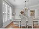 Elegant dining room featuring wainscoting, chandelier, and natural light at 240 Longmead Dr, Fayetteville, GA 30215