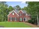 Classic brick home with a manicured lawn and mature trees at 240 Longmead Dr, Fayetteville, GA 30215