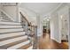 Inviting foyer showcasing hardwood floors, a staircase with a wrought iron railing, and open doorways at 240 Longmead Dr, Fayetteville, GA 30215