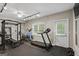 Bright home gym featuring several machines, mirror, and gym flooring at 240 Longmead Dr, Fayetteville, GA 30215