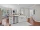 Spacious kitchen features a large island with a farmhouse sink, stainless steel dishwasher, and barstool seating at 240 Longmead Dr, Fayetteville, GA 30215
