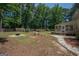 Spacious backyard with a fire pit and beautiful landscaping, great for outdoor activities and entertaining at 101 Bluegill Trce, Peachtree City, GA 30269