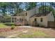 Home's backyard featuring a spacious deck and sunroom surrounded by mature trees and lush greenery at 101 Bluegill Trce, Peachtree City, GA 30269