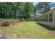 Spacious backyard featuring a well-maintained lawn, mature trees, and a sunroom addition at 101 Bluegill Trce, Peachtree City, GA 30269