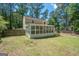 Lush backyard showcasing a sunroom, a well-maintained lawn, and a fence-lined perimeter at 101 Bluegill Trce, Peachtree City, GA 30269