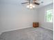 Cozy bedroom featuring a ceiling fan, carpeted floors, and a window at 101 Bluegill Trce, Peachtree City, GA 30269