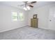 Relaxing bedroom featuring a ceiling fan, carpeted floors, and a window at 101 Bluegill Trce, Peachtree City, GA 30269