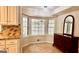 Bright breakfast nook with large windows overlooking the sunroom and a dark dresser at 101 Bluegill Trce, Peachtree City, GA 30269