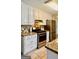 Well-lit kitchen featuring stainless steel appliances, granite countertops, and ample white cabinetry at 101 Bluegill Trce, Peachtree City, GA 30269