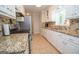 Bright kitchen with granite counters, stainless appliances, and tile backsplash at 101 Bluegill Trce, Peachtree City, GA 30269