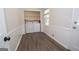 Bright laundry room with wainscoting, wood-look floors, and a washer and dryer in a closet at 101 Bluegill Trce, Peachtree City, GA 30269