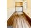 Bright laundry room with wainscotting, featuring a washer, a dryer and wood floors at 101 Bluegill Trce, Peachtree City, GA 30269