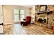 Cozy living room with a brick fireplace, built-in shelves, and large bright windows at 101 Bluegill Trce, Peachtree City, GA 30269