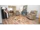 Sitting area with a rug, two chairs, and a view of the dining room at 101 Bluegill Trce, Peachtree City, GA 30269