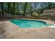 Inviting backyard pool with an in-ground spa and concrete deck perfect for outdoor entertaining at 101 Bluegill Trce, Peachtree City, GA 30269