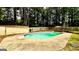 Backyard with a large in-ground pool and a wooden fence surrounding the area at 101 Bluegill Trce, Peachtree City, GA 30269
