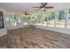 Light-filled sunroom featuring wood-look floors and multiple windows overlooking the backyard at 101 Bluegill Trce, Peachtree City, GA 30269