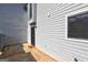 Back door entrance with black metal screen door and 'Stay Awhile' welcome mat, and vinyl siding at 313 Country Club Dr, Jonesboro, GA 30238