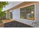 Exterior view highlighting a patio, large window, siding, and landscaping features enhancing outdoor living at 313 Country Club Dr, Jonesboro, GA 30238