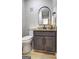 Powder room boasts a modern vanity, decorative mirror, and tiled floor at 313 Country Club Dr, Jonesboro, GA 30238