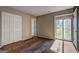 Inviting bedroom with carpeted floors, a double closet, and a bright window with pleasant backyard views at 313 Country Club Dr, Jonesboro, GA 30238