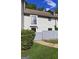 Front exterior showcasing a well-maintained yard, gray siding, and charming architectural details at 313 Country Club Dr, Jonesboro, GA 30238