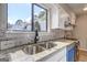 Bright kitchen featuring granite countertops, stainless steel sink, and updated backsplash at 313 Country Club Dr, Jonesboro, GA 30238