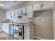 Well-lit kitchen featuring white cabinets, stainless steel appliances, and a matching backsplash at 313 Country Club Dr, Jonesboro, GA 30238