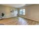 Spacious living room with wood floors, and natural light coming through a window at 313 Country Club Dr, Jonesboro, GA 30238