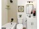 Charming bathroom featuring a tub and shower combination, modern vanity, and decorative accents at 1091 Pine St, Conyers, GA 30012