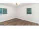 Bright bedroom with wood floors, white walls, and two windows providing ample natural light at 1091 Pine St, Conyers, GA 30012